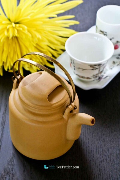 This pretty Brass Handled Yixing Teapot is made with light mustard yellow clay. It measures 2½ inches in diameter and is 2¾ inches in height. | TeaTattler.com #brasshandledteapot #yixingteapot #coppergirderteapot