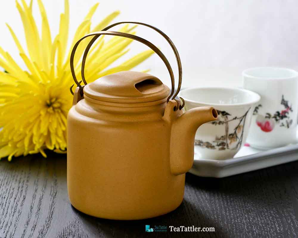 This pretty Brass Handled Yixing Teapot is made with light mustard yellow clay. It measures 2½ inches in diameter and is 2¾ inches in height. | TeaTattler.com #brasshandledteapot #yixingteapot #coppergirderteapot