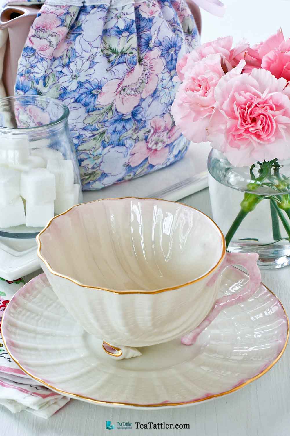 Neptune Seashell, Belleek - a delicate soft pink scooped shell teacup with two tiny conch shell feet and sculptured coral handle. | TeaTattler.com #neptuneseashellteacup #belleek