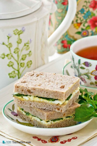 Dainty Egg and Watercress Sandwiches with hard cooked eggs and mayonnaise. Watercress provides a slightly peppery bite to the sandwiches. | TeaTattler.com #watercresseggsandwiches #eggsandwiches