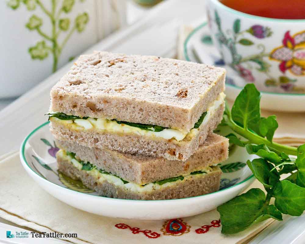 Dainty Egg and Watercress Sandwiches with hard cooked eggs and mayonnaise. Watercress provides a slightly peppery bite to the sandwiches. | TeaTattler.com #watercresseggsandwiches #eggsandwiches