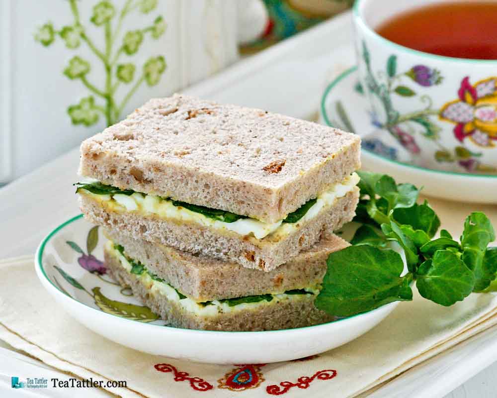 Dainty Egg and Watercress Sandwiches with hard cooked eggs and mayonnaise. Watercress provides a slightly peppery bite to the sandwiches. | TeaTattler.com #watercresseggsandwiches #eggsandwiches